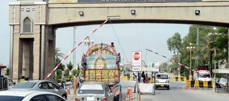TO GO WITH Pakistan-Unrest-Housing-property,FEATURE by Guillaume LAVALL…E

(FILES) In this photograph taken on October 2, 2013, Pakistani motorists drive through the main entrance at the Bahria Town private develpoment in Rawalpindi. Unlike some major Pakistani cities torn by an unprecedented wave of killings and kidnappings, the private development of Bahria offerselites and rising middle class Pakistanis a residential oasis protected from militant attacks and electrical blackouts. AFP PHOTO/Farooq NAEEM/FILES